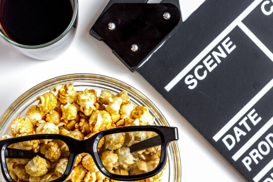 concept of watching movies with popcorn top view white background