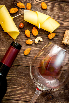 red wine with cheese on wooden background top view