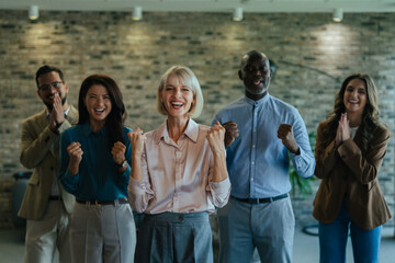 Fototapeta premium Diverse business team celebrating success and achievement in office