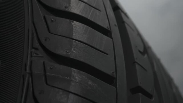 Tire Smokes While Drifting. The spinning wheel rubs against the asphalt and creates a cloud of white smoke on a black background
