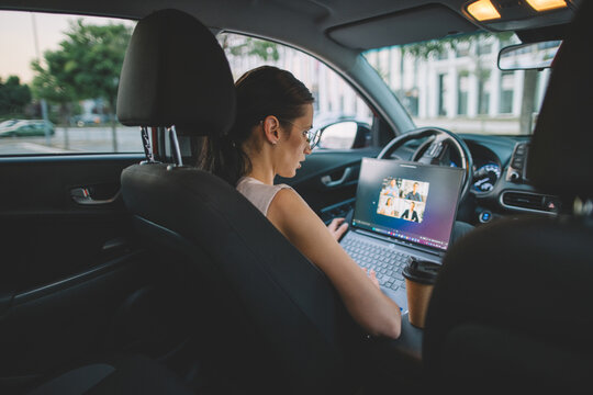 Businesswoman joining video meeting from parked car