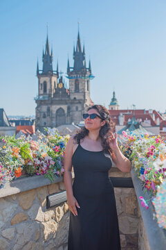 Happy American woman tourist enjoying outdoor street  historic European city center, autumn travel lifestyle and culture concept