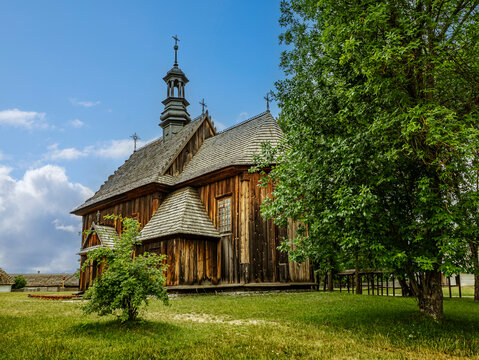 Historic Wooden Church With Shingled Roof and Bell Tower