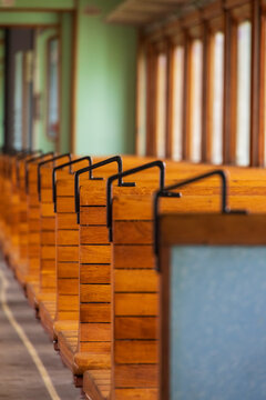 View of the interior of a vintage train carriage with wooden benches and metal handles at the Railway Park in Vilnius, Vilniaus apskritis, Lithuania.