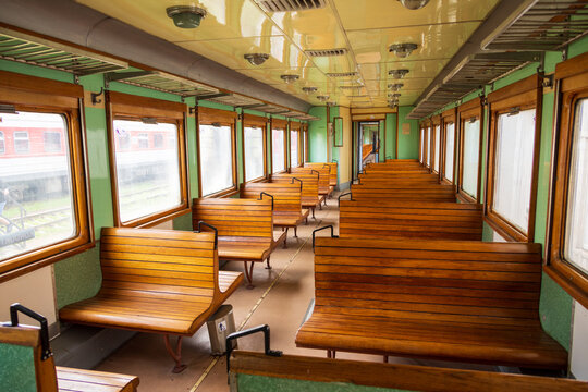 View of the interior of a vintage train carriage featuring wooden benches and green walls at the Railway Park in Vilnius, Vilniaus apskritis, Lithuania.