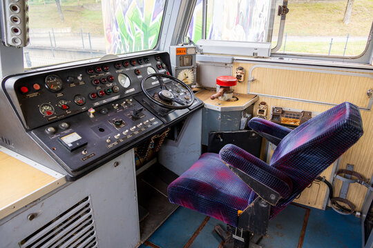 View of the interior of a vintage train locomotive cab featuring a control panel, gauges, and a driver seat at Railway Park in Vilnius, Vilniaus apskritis, Lithuania.