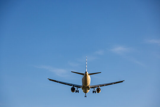View of a commercial airliner with landing gear extended approaching Vilnius International Airport in Vilnius, Vilniaus apskritis, Lithuania.