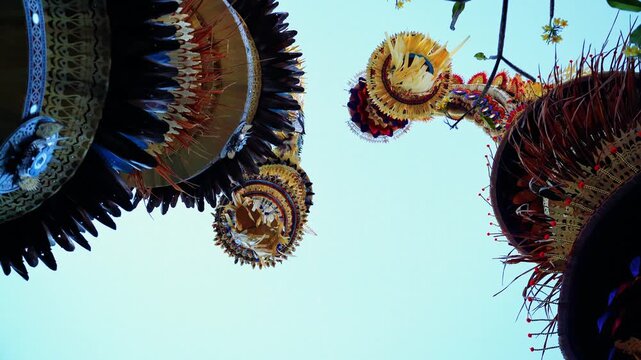 Tall decorative bamboo pole penjor erected for Galungan Hindu festival along street, Bali, Indonesia