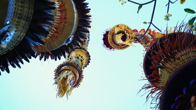 Tall decorative bamboo pole penjor erected for Galungan Hindu festival along street, Bali, Indonesia
