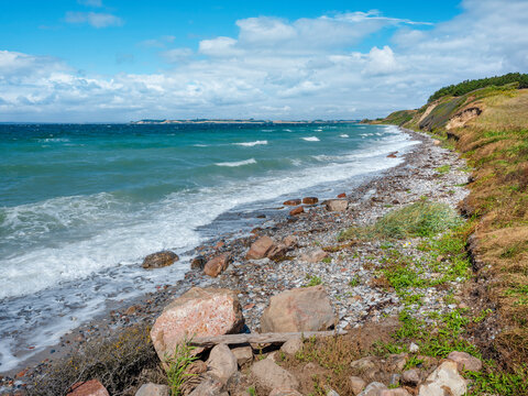 Untouched coastal landscape with boulders and stormy sea, Aarhus bay, Kattegat, Djursland, Denmark