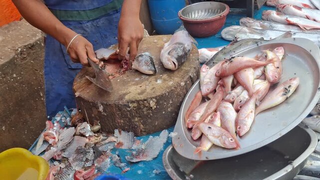 Fresh fish cutting on a large wooden chopping block at a bustling local fish market, showcasing traditional preparation, freshness, and skilled craftsmanship