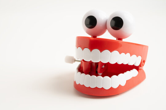 Tooth funny toy denture red color jaw and eye.