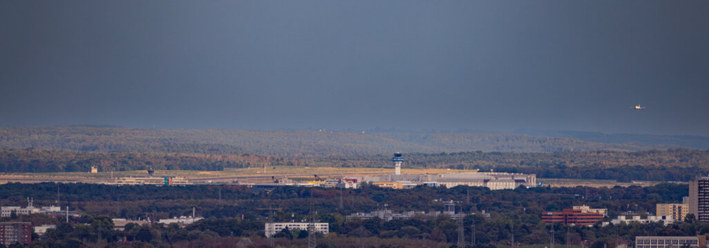 K&ouml;ln Bonn Airport (CGN) control tower with airplane flying
