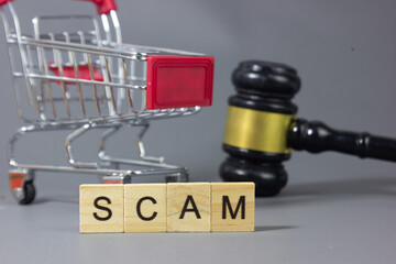 Shopping cart with a note labeled SCAM, symbolizing illegal markets, fraudulent transactions, consumer deception, financial loss, shopping risks, legal consequences, law enforcement © bizdof photo