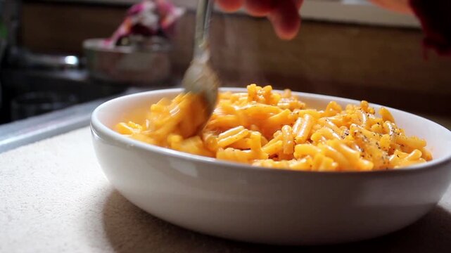 Stirring A Bowl Of Macaroni & Cheese