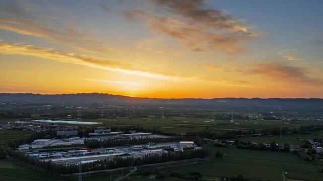 Aerial Video of Sunrise over Highway Service Area with Farmland and Trucks