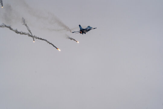 View of an F-16C Fighting Falcon of the Turkish Air Force performing aerial maneuvers and releasing flares during the Antidotum Airshow in Leszno, Greater Poland Voivod, Poland.