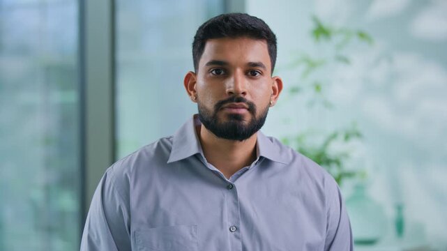 Portrait serious Arabian businessman looking at camera confident Muslim business man work posing in modern office focused Hindu male guy professional manager executive agent look working in company