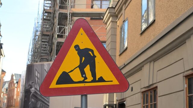 Roadworks ahead warning traffic sign. Construction zone warning traffic sign. Temporary roadworks ahead.