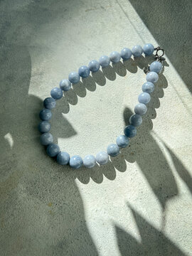 Quartz stone necklace in soft natural light. Handmade jewelry, fashion and beauty concept