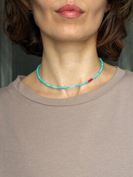 Stylish woman wearing gemstone choker - modern minimalist portrait in natural light