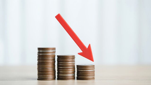 Stacks of coins with downward arrow indicating financial decline or loss in savings