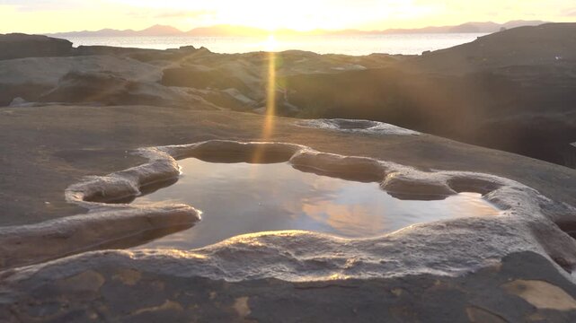 Tide pool at tropical sunset at full tide on the shores of the Andaman Sea and the coast of Thailand.