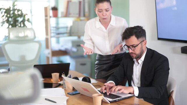 Female boss yells at man employee, girl work at computer and reprimanded by management. Boss is dissatisfied with quality of work, is outraged by unsatisfactory competence of employee 