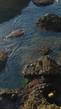 Clear mediterranean sea gently washing over coastal rocks on the sunny coast of Nerja, Spain