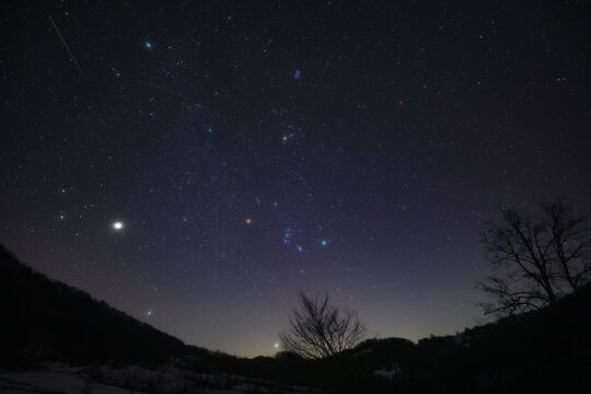 Orion constellation, zodiacal light and Milky Way stars on a dark countryside skies.