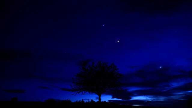 Crescent Moon, planet conjunction and landscape scenery silhouettes.