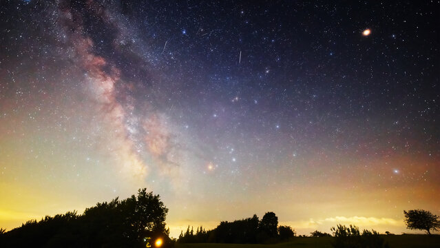 Summer Milky Way stars and landscape scenery silhouettes.