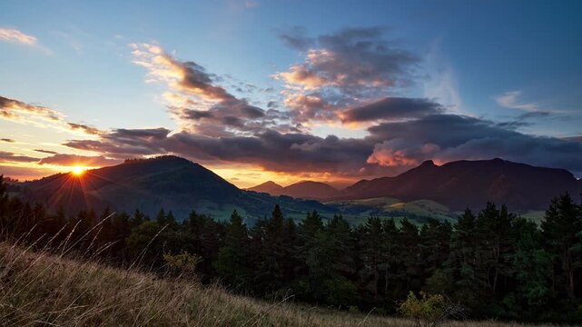 Sunset Timelapse Over Mountain Ridge with Sun Flare and Dramatic Clouds