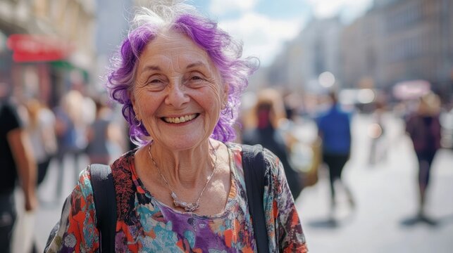Elderly woman with vibrant purple hair smiles warmly at the camera, surrounded by a bustling street scene filled with people, showcasing joy and community spirit in urban life