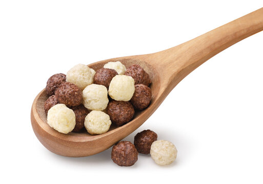 Sweet cereal balls in wooden spoon close-up on a white background. Isolated