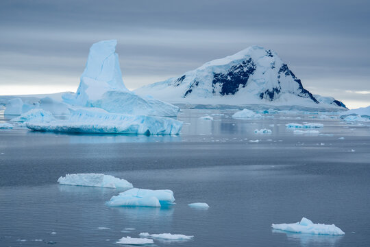Antarctica: landscapes of a floating iceberg and pack ice.