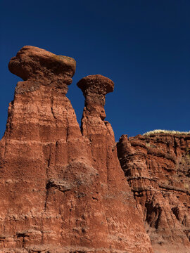 Low angle view of rock formation against clear blue sky