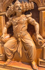 Fototapeta premium Intricate wooden carved sculpture of ten headed Ravana from Indian mythology