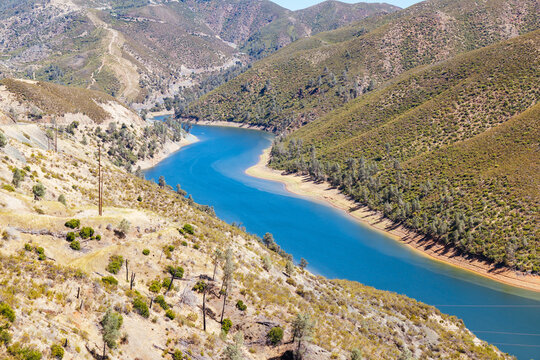 Elevated view of a reservoir winding through chaparral hills in the Sierra Nevada foothills of California.