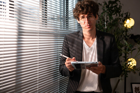Portrait of business professional using a tablet and stylus in a modern office,