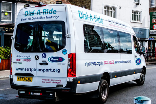 Close-Up Of A Buses 4U Dail-A-Ride Community Transport Minibus Driving On A Town Centre Main Road