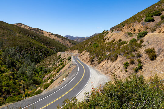 Winding scenic mountain highway curves through dry landscape in Mariposa County California
