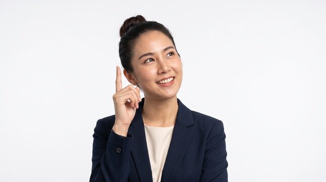 Inspired Asian businesswoman pointing up and looking at creative idea