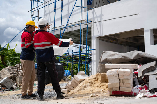 Construction engineers reviewing blueprints and inspecting a residential building site with scaffolding, emphasizing project planning, structural safety, quality control, teamwork, site supervision.