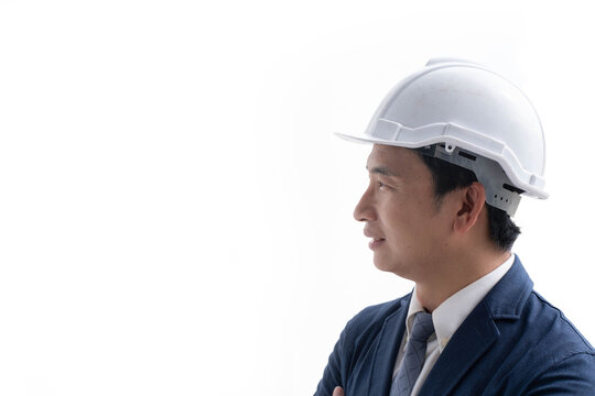 Construction engineer wearing a white safety helmet and business suit, isolated on a white background, representing engineering, construction, leadership, safety, professionalism, project management.