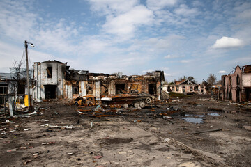 Fototapeta premium War-Damaged Buildings with Destroyed Military Vehicle and Rubble