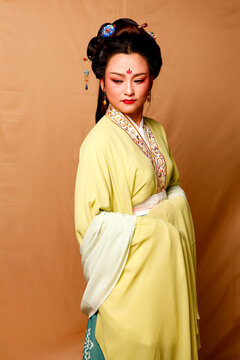 Elegant East Asian Woman in Traditional Yellow Hanfu Studio Portrait