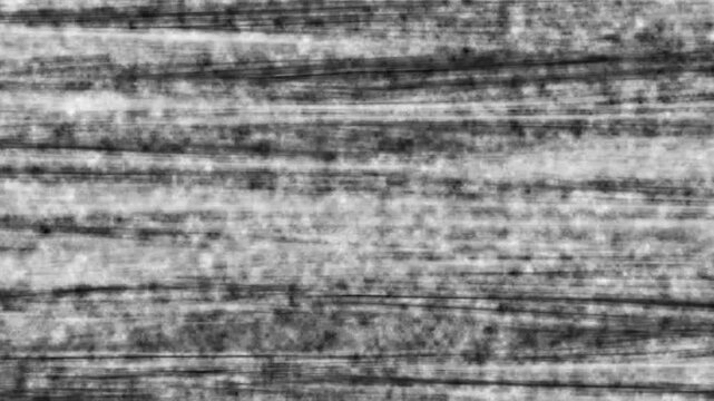 Abstract grey grunge background texture with horizontal scratches and rough dark overlay