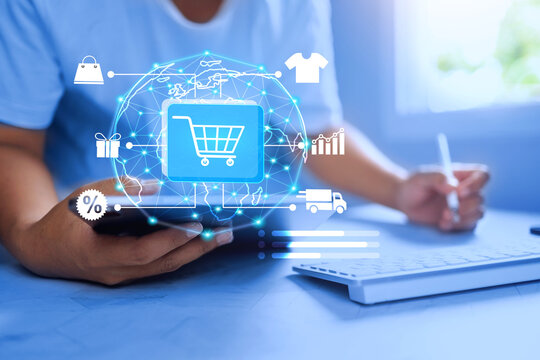 e-commerce concept with a man working on table and using computer to check up total sales and contact partners online market platform