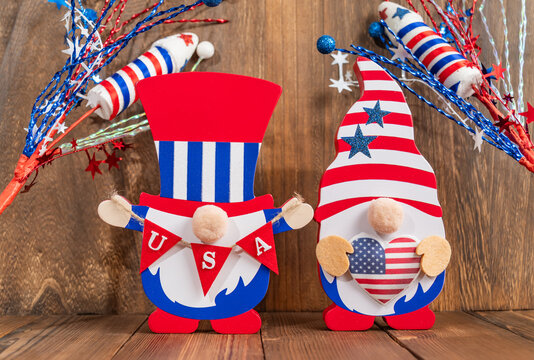 Patriotic gnome holding an American flag, wearing a festive hat.